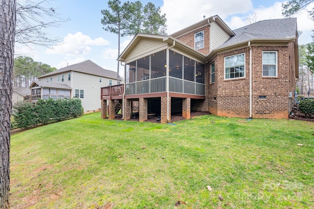 back of property with a yard, brick siding, and a sunroom