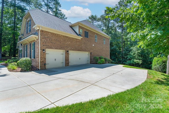 303 Ridge Reserve Dr Unit 29, Clover, SC 29710 - view of home's exterior featuring brick siding, an attached garage, driveway, and roof with shingles