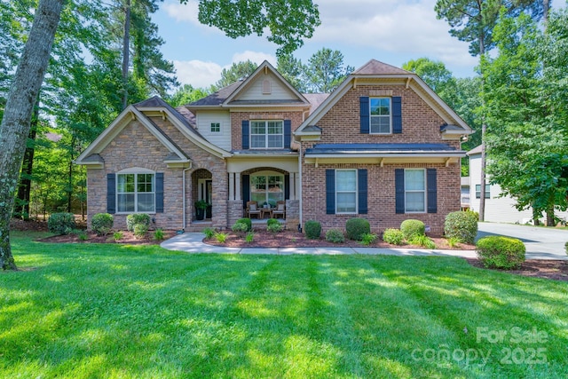 303 Ridge Reserve Dr Unit 29, Clover, SC 29710 - craftsman-style house with a front yard, brick siding, and covered porch