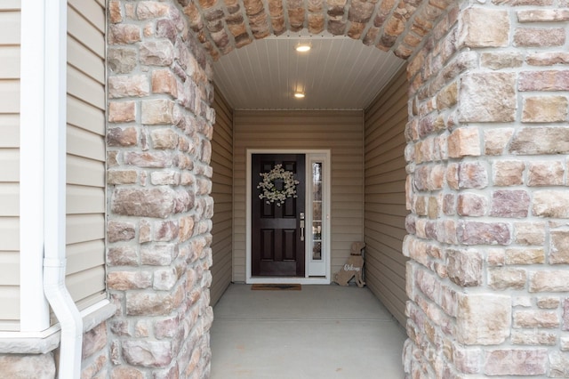 entrance to property with stone siding