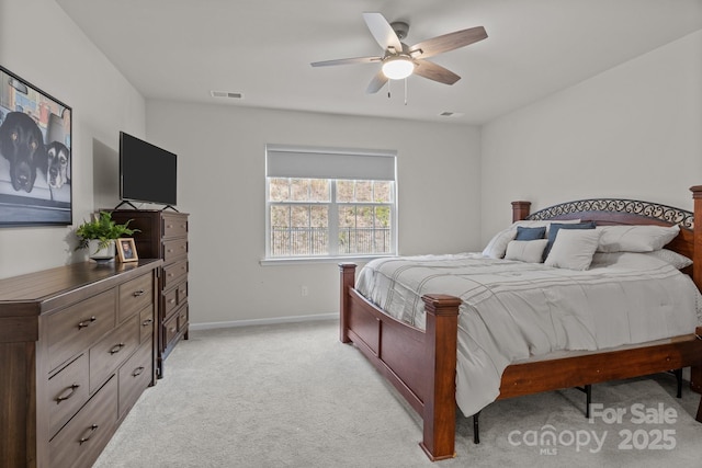 bedroom featuring ceiling fan, light colored carpet, visible vents, and baseboards