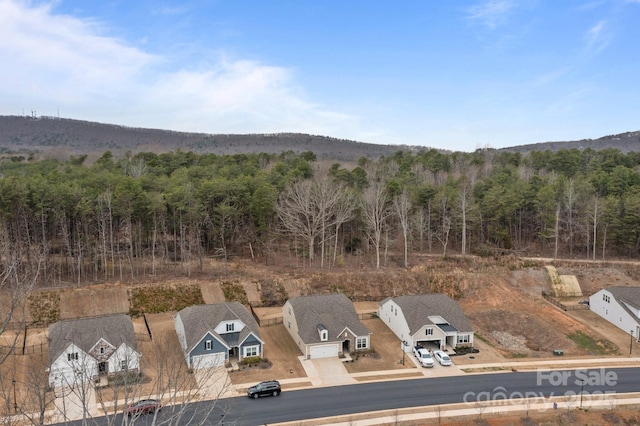 birds eye view of property featuring a wooded view