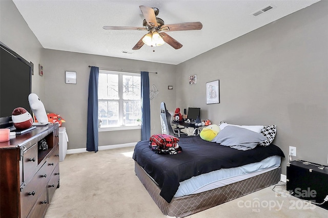 bedroom with light carpet, visible vents, ceiling fan, and baseboards