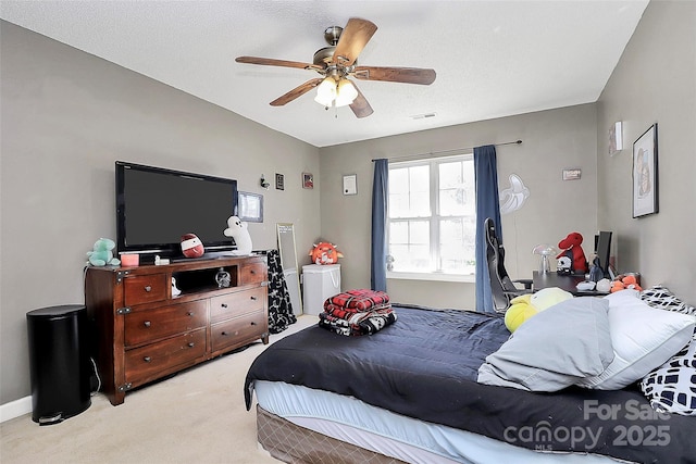 bedroom featuring visible vents, baseboards, light colored carpet, and ceiling fan