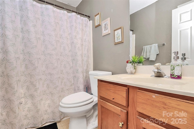 bathroom with vanity, curtained shower, toilet, and tile patterned flooring