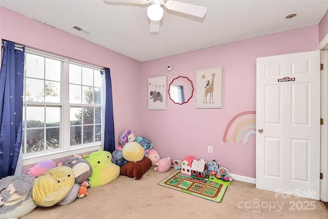 game room featuring visible vents, a textured ceiling, ceiling fan, and carpet floors