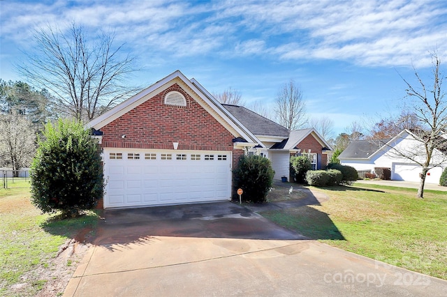 view of front facade with a front yard, a garage, brick siding, and driveway