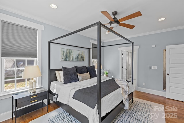 bedroom with recessed lighting, crown molding, baseboards, and wood finished floors