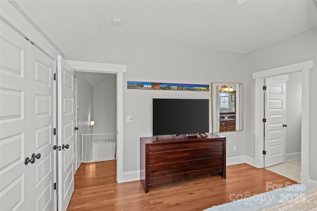 bedroom with light wood-type flooring and baseboards