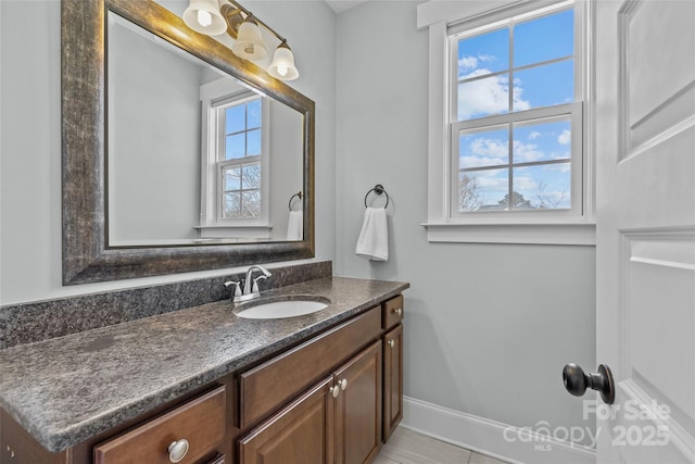 bathroom featuring baseboards and vanity