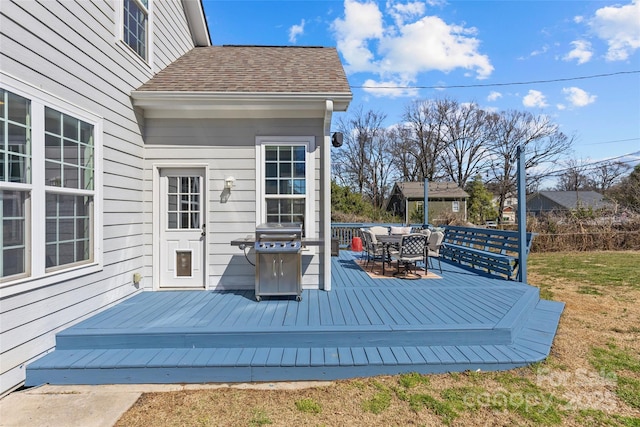 wooden deck featuring outdoor dining space and a grill