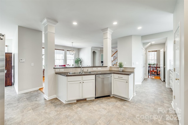 kitchen with a sink, a healthy amount of sunlight, ornate columns, and stainless steel dishwasher