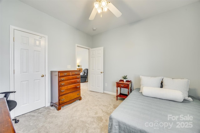 bedroom with light colored carpet and a ceiling fan