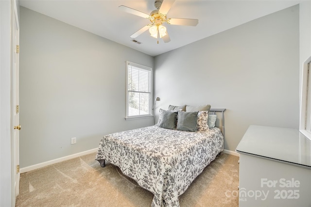 bedroom featuring visible vents, baseboards, ceiling fan, and carpet flooring