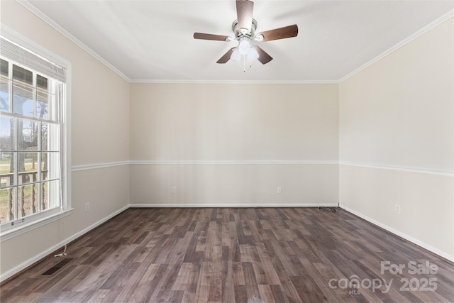 empty room with visible vents, ornamental molding, a ceiling fan, and wood finished floors