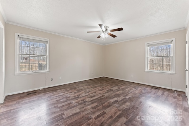 empty room featuring visible vents, ornamental molding, a ceiling fan, a textured ceiling, and dark wood-style floors