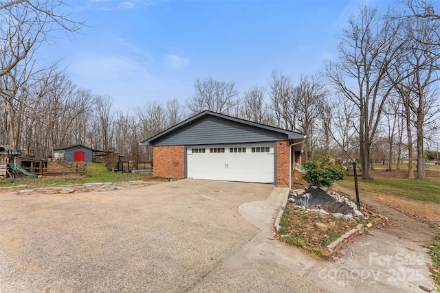 view of side of property featuring brick siding and driveway