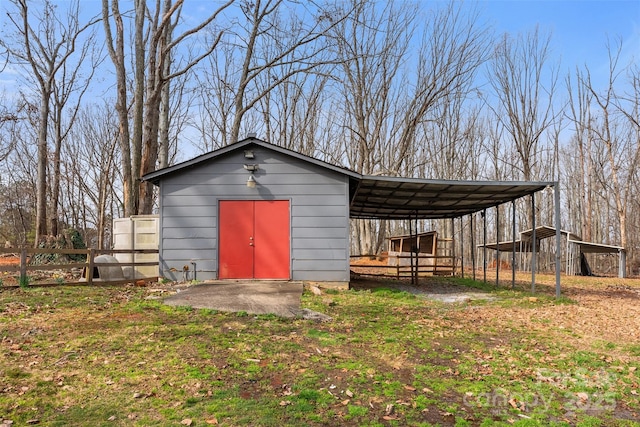 view of pole building with a carport and fence