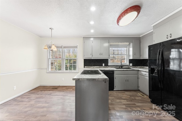822 Bethlehem Rd, Kings Mountain, NC 28086 - kitchen featuring black appliances, a textured ceiling, plenty of natural light, backsplash, and wood finished floors