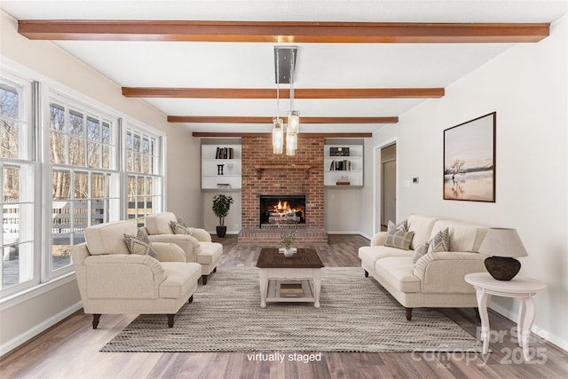 822 Bethlehem Rd, Kings Mountain, NC 28086 - living area with wood finished floors, beam ceiling, baseboards, a fireplace, and built in features