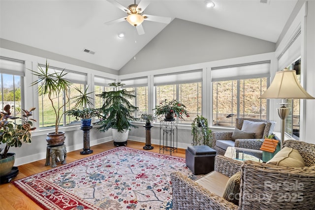 sunroom / solarium with visible vents, lofted ceiling, and ceiling fan