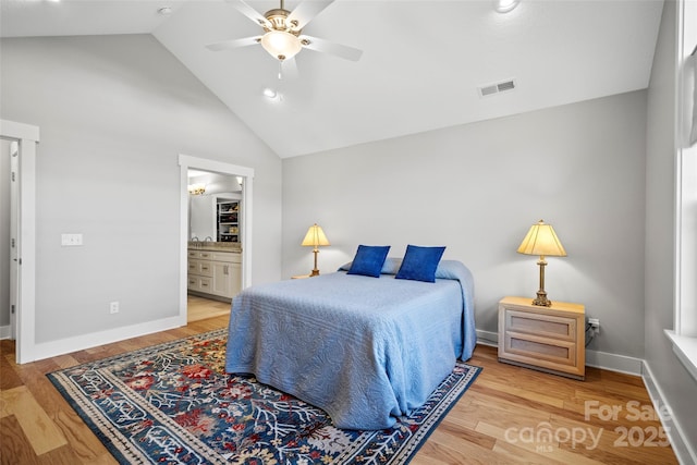 bedroom featuring visible vents, baseboards, light wood-style floors, and ensuite bathroom