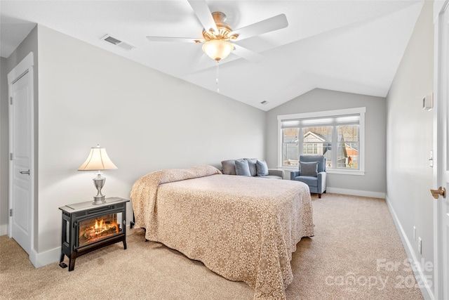 bedroom with visible vents, baseboards, light colored carpet, vaulted ceiling, and a ceiling fan