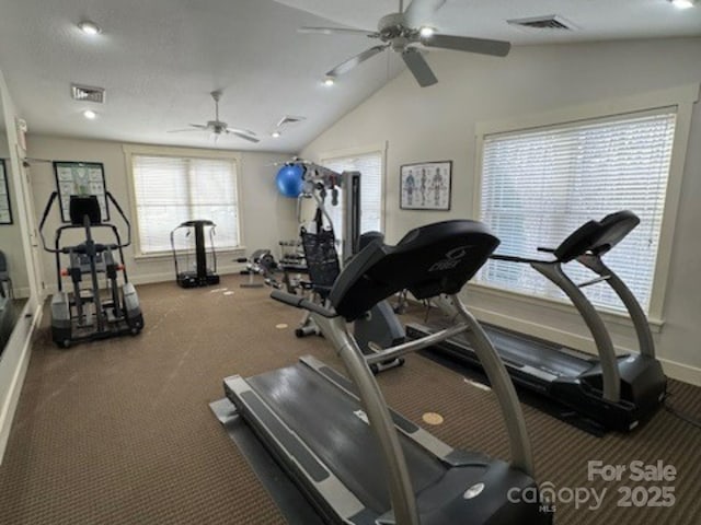 gym with visible vents, baseboards, ceiling fan, and vaulted ceiling