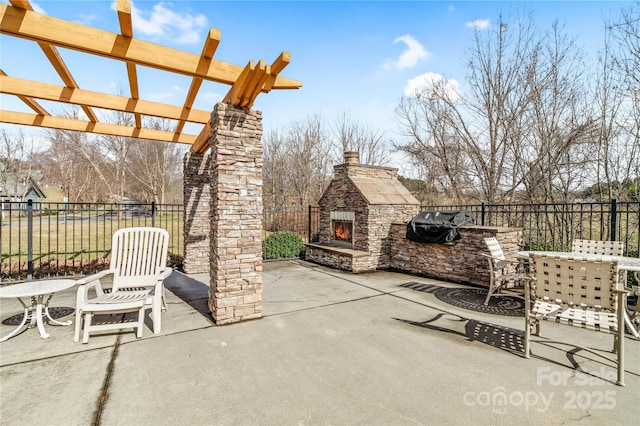 view of patio with an outdoor stone fireplace, a pergola, and fence