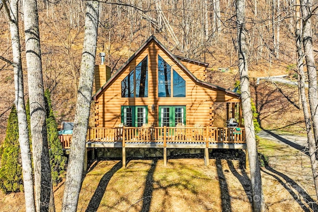 view of front of house with a chimney and a wooden deck