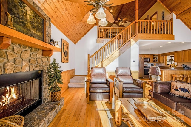 living room with stairway, wood ceiling, light wood-type flooring, and ceiling fan