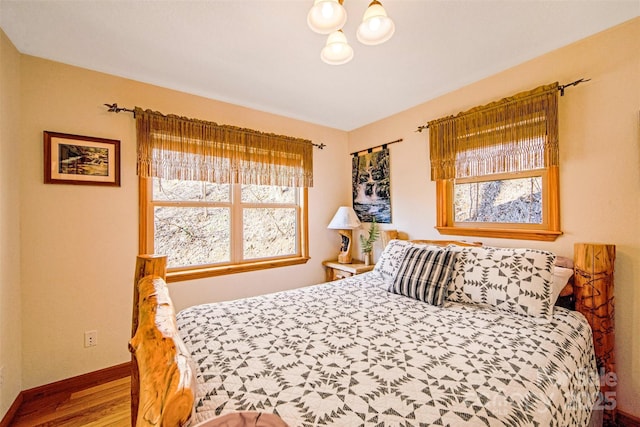 bedroom featuring wood finished floors and baseboards