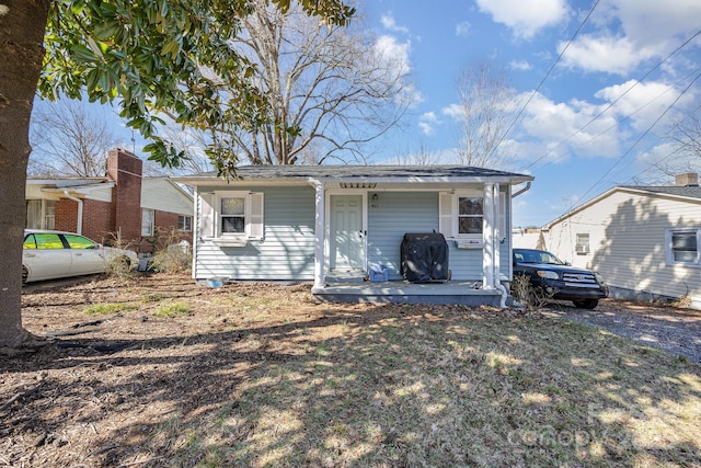 rear view of house featuring a porch