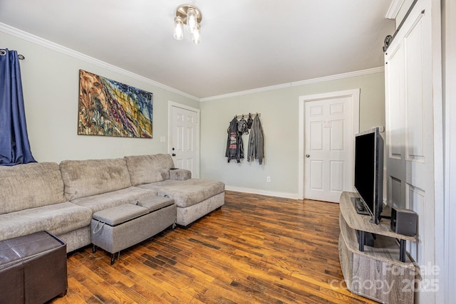 living room with a barn door, wood finished floors, baseboards, and ornamental molding