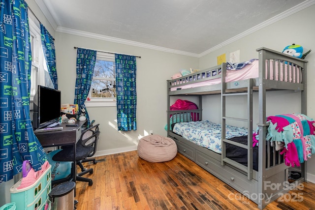 bedroom featuring wood finished floors, baseboards, and ornamental molding