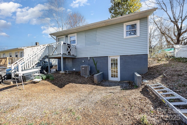 back of house with central AC unit, stairs, and a deck