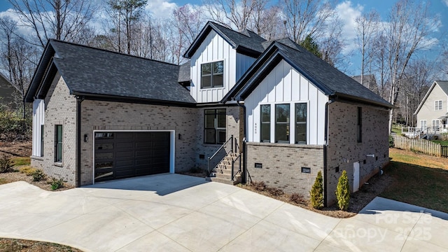 modern farmhouse style home featuring fence, driveway, crawl space, board and batten siding, and brick siding