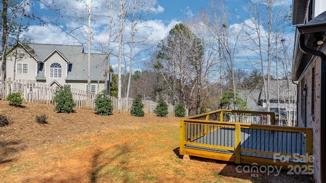 view of yard with a wooden deck and fence