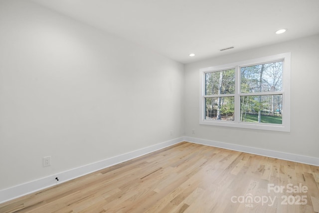 spare room featuring recessed lighting, visible vents, baseboards, and wood finished floors