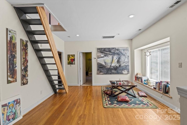 interior space with visible vents, recessed lighting, stairs, and wood finished floors