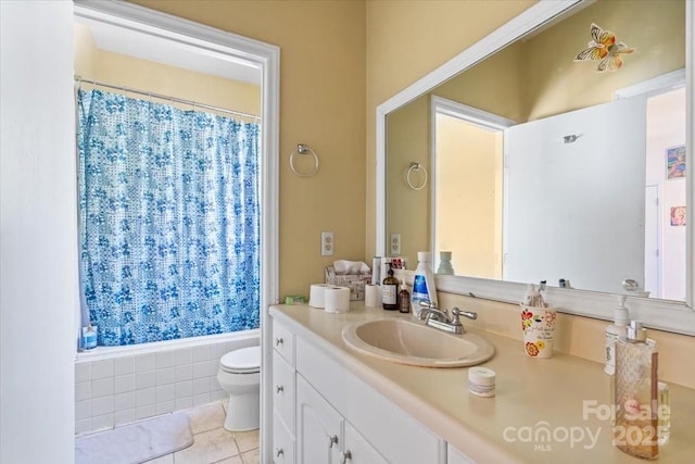 bathroom with tile patterned floors, curtained shower, toilet, and vanity