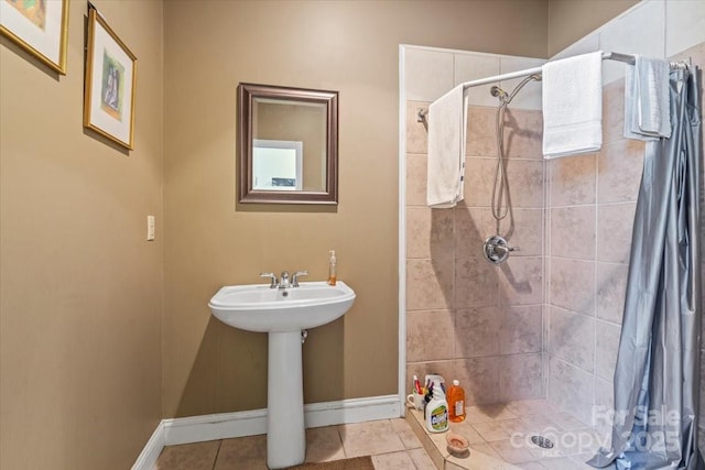 full bath with tile patterned flooring, a shower stall, and baseboards