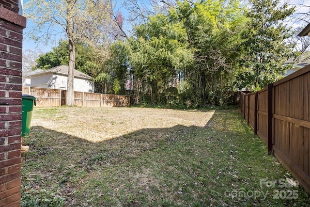 view of yard with a fenced backyard