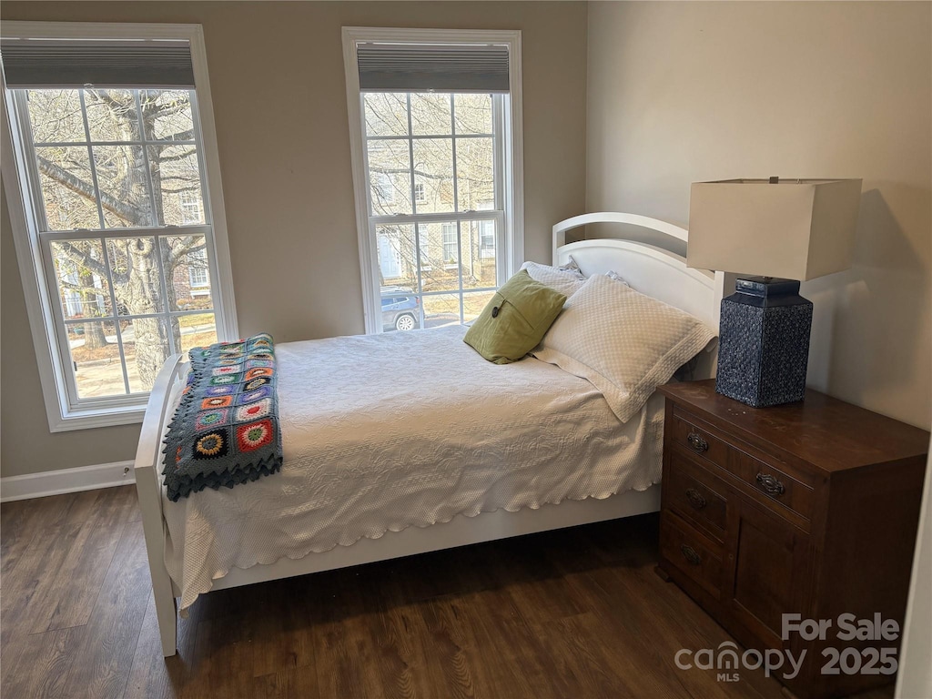 bedroom with dark wood-style flooring