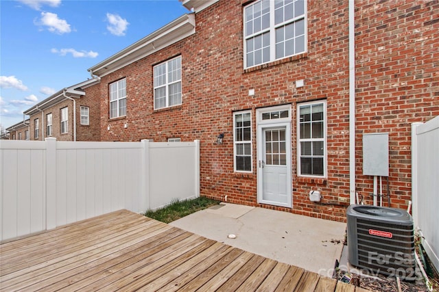 deck featuring cooling unit, a patio area, and fence