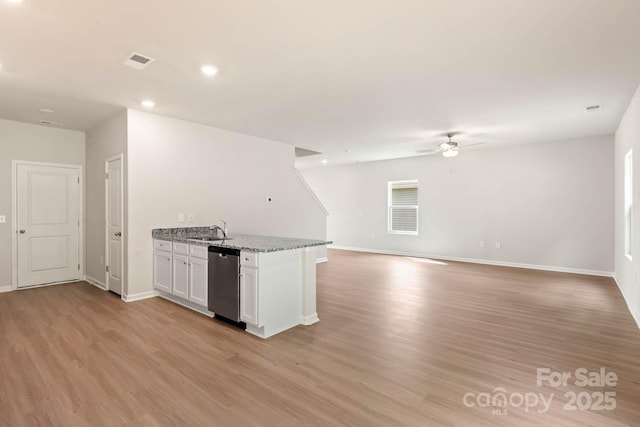 kitchen featuring visible vents, a sink, stainless steel dishwasher, white cabinetry, and light wood-style floors