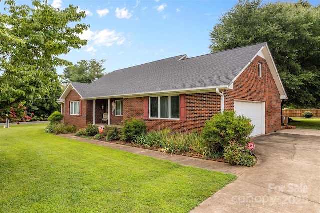 ranch-style house with driveway, a front lawn, fence, roof with shingles, and brick siding