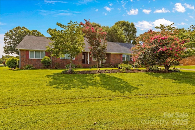 ranch-style house with brick siding and a front yard