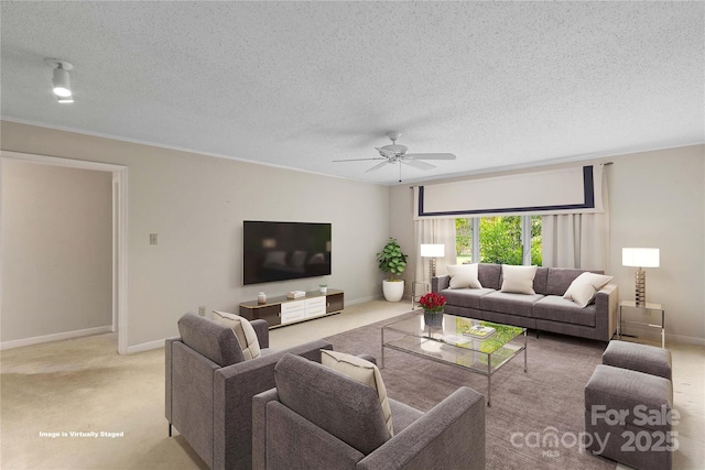 carpeted living area featuring baseboards, a textured ceiling, and ceiling fan