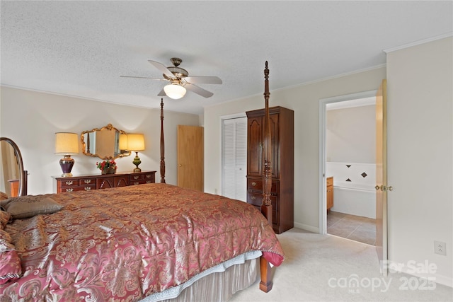 bedroom featuring a closet, light colored carpet, ornamental molding, and a textured ceiling